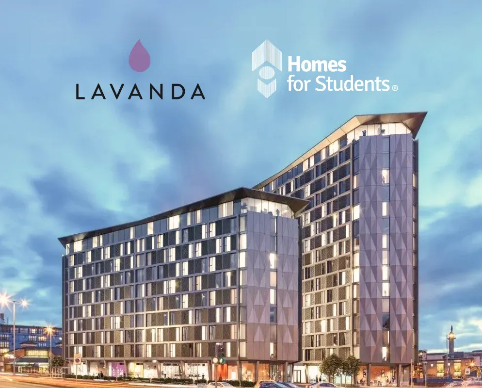 A lit student accommodation block at dusk, beneath the Lavanda and Homes for Students logos.
