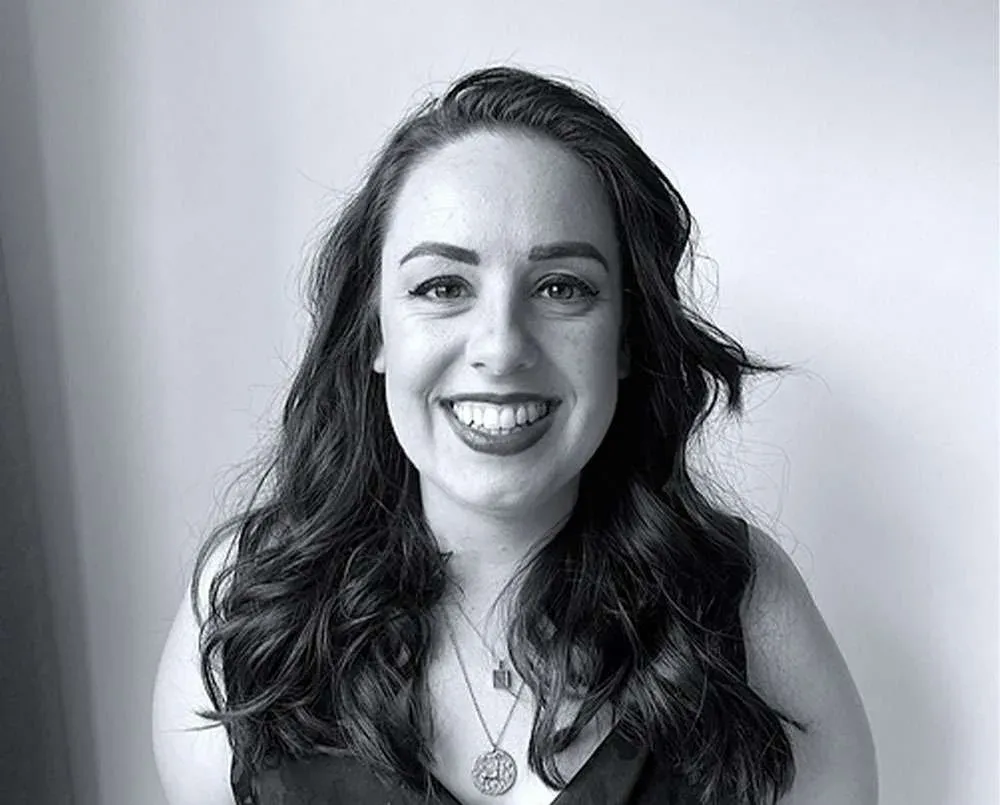 A black-and-white portrait of Sarah Mahoney, Product Designer.