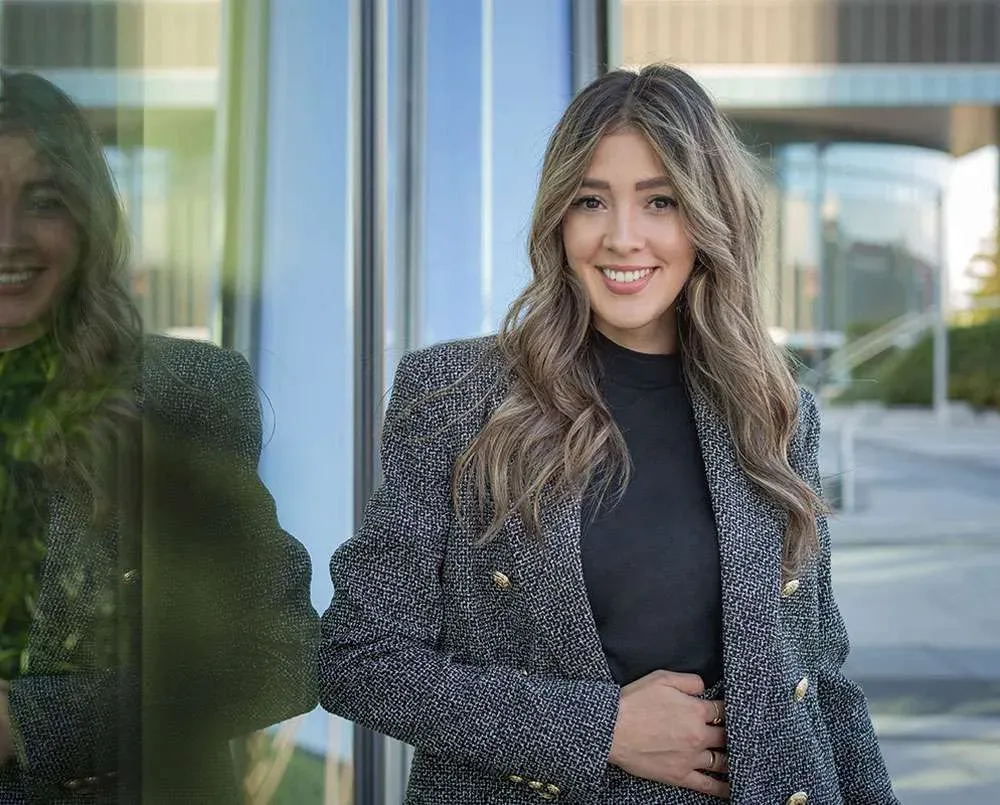 A portrait of Silvia Gonzalez, Senior Expansion Manager, beside a window.