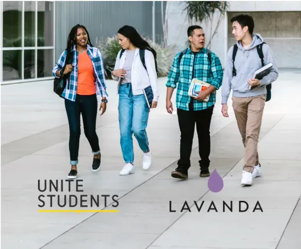 Four students walking together along a campus path carrying books and backpacks, above the Unite Students and Lavanda logos.